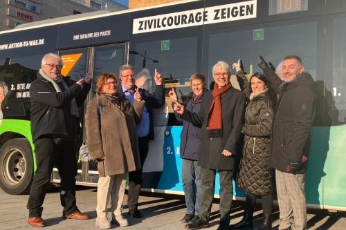 Vertreter:innen von Polizei, Stadt Esslingen, Landkreis Esslingen und dem Städtischen Verkehrsbetrieb stehen auf dem Bahnhofsplatz vor dem Zivilcourage-Bus