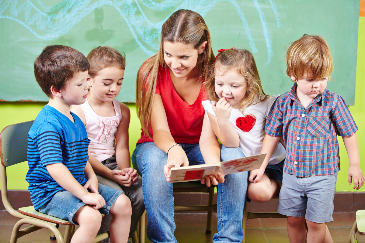 Kita Erzieherin liest Kindern in der Kita vor