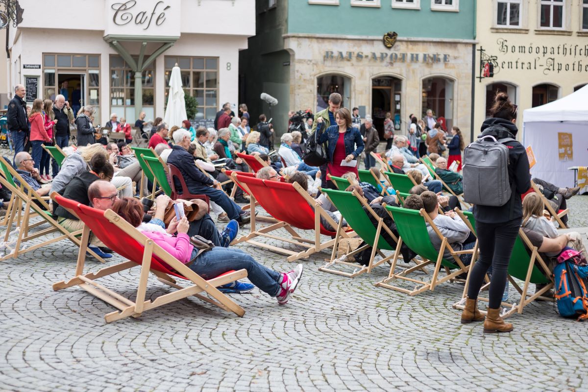 Publikum in Liegestühlen auf dem Rathausplatz sitzend