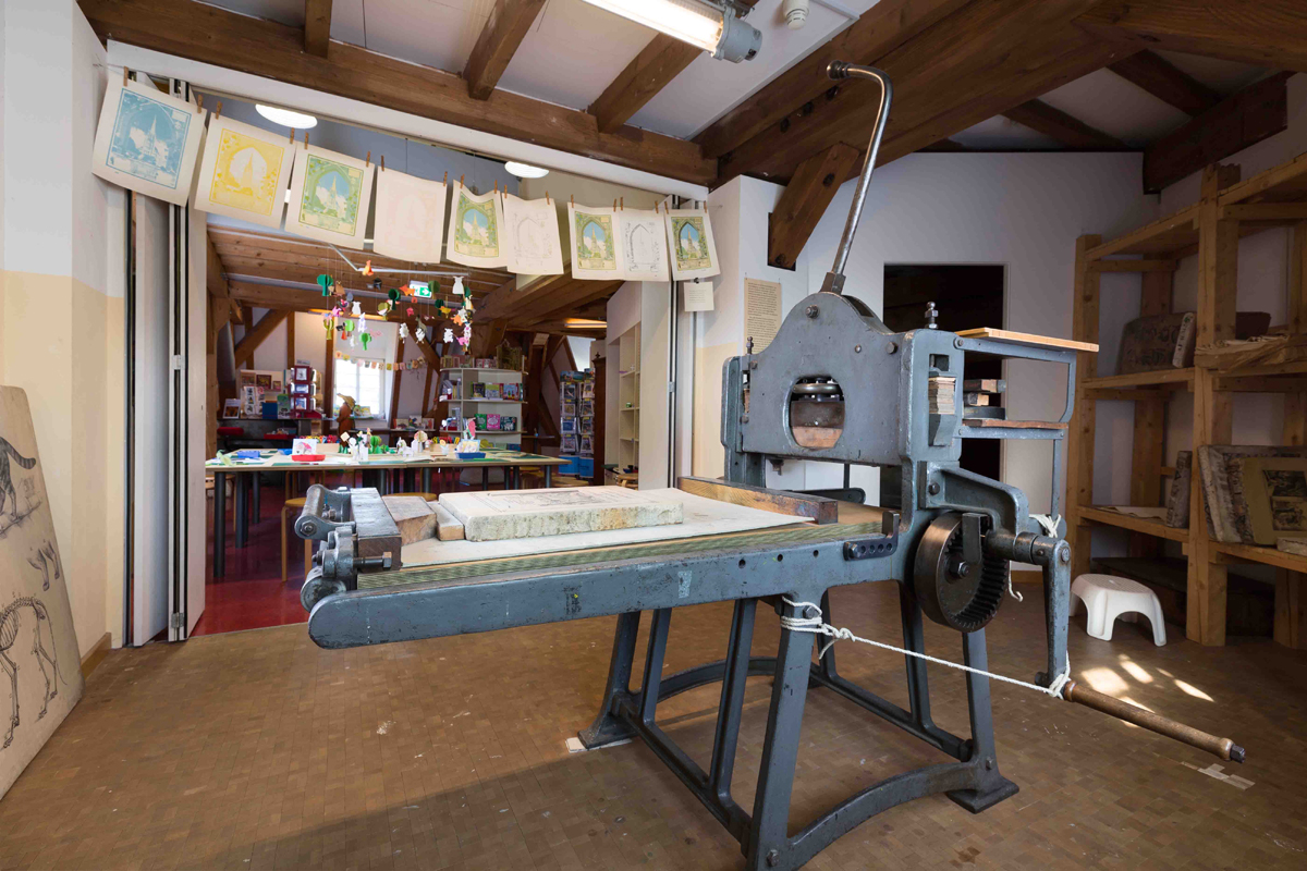 Im Museum: Raum mit alter Litographie-Presse, im Hintergrund der Kreativbereich.