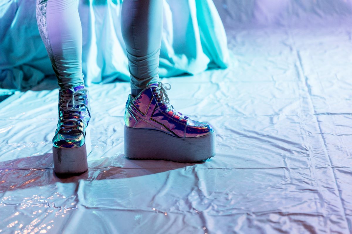 Plateauschuhe, Stadt der Frauen* © Dominique Brewing Füße in Plateauschuhen auf weißem Boden